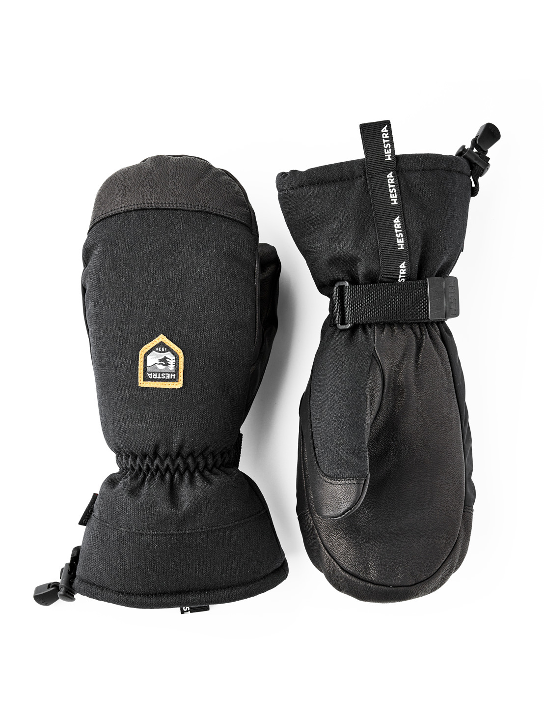 Black Hestra mittens Two black Hestra mittens on a white background. A logo can be seen on one mitten.
