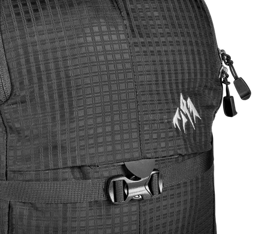 Close-up of the black Jones DSCNT 19L backpack with logo, zippers and a black click closure.