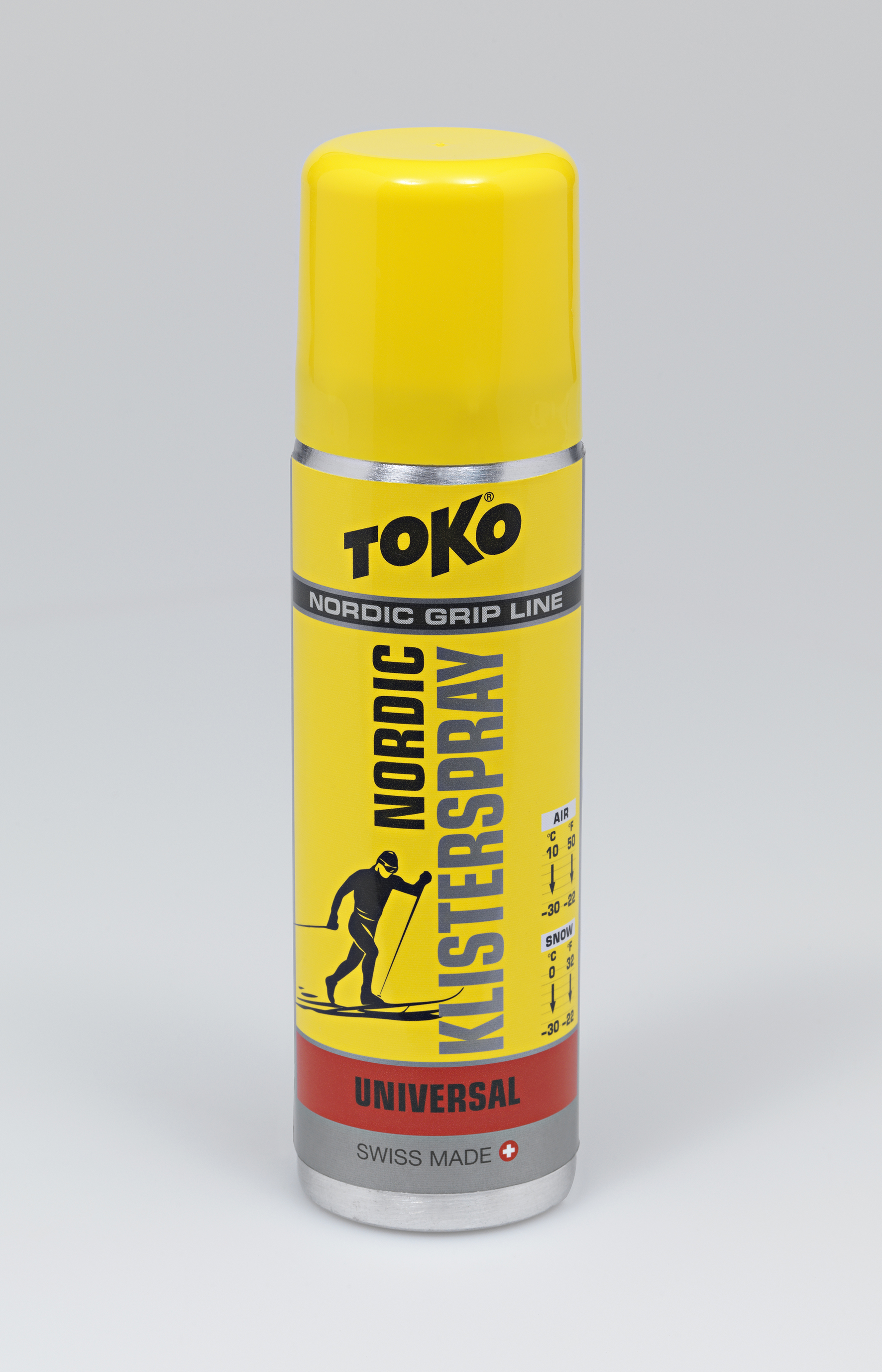 Gelbe Spraydose Toko Nordic KlisterSpray Universal mit Skifahrer-Illustration und Temperaturbereich.