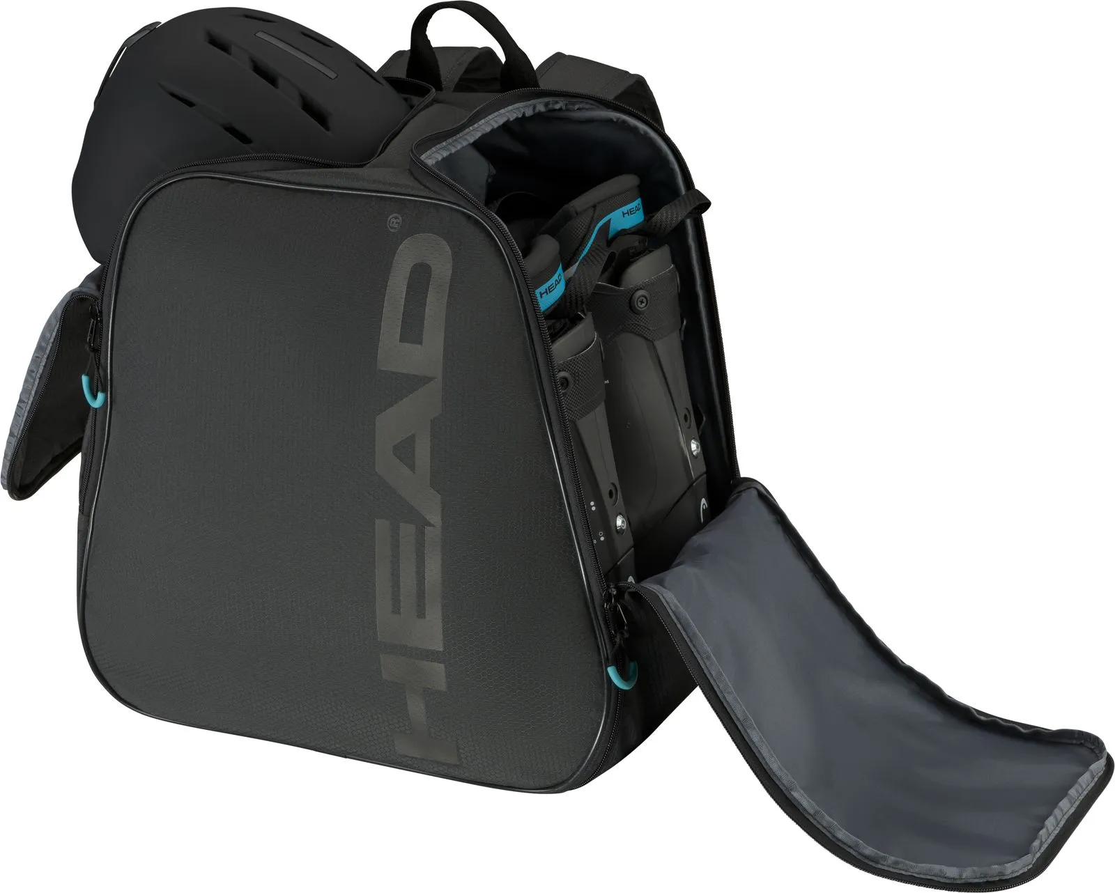 Sac à dos Head Boot noir avec casque et chaussures de ski. Le sac a des compartiments ouverts.