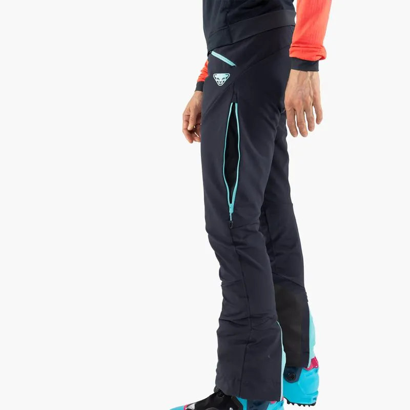 Vista dettagliata dei pantaloni Dynafit TLT Touring DST da donna in blu, con zip laterale e logo visibili.