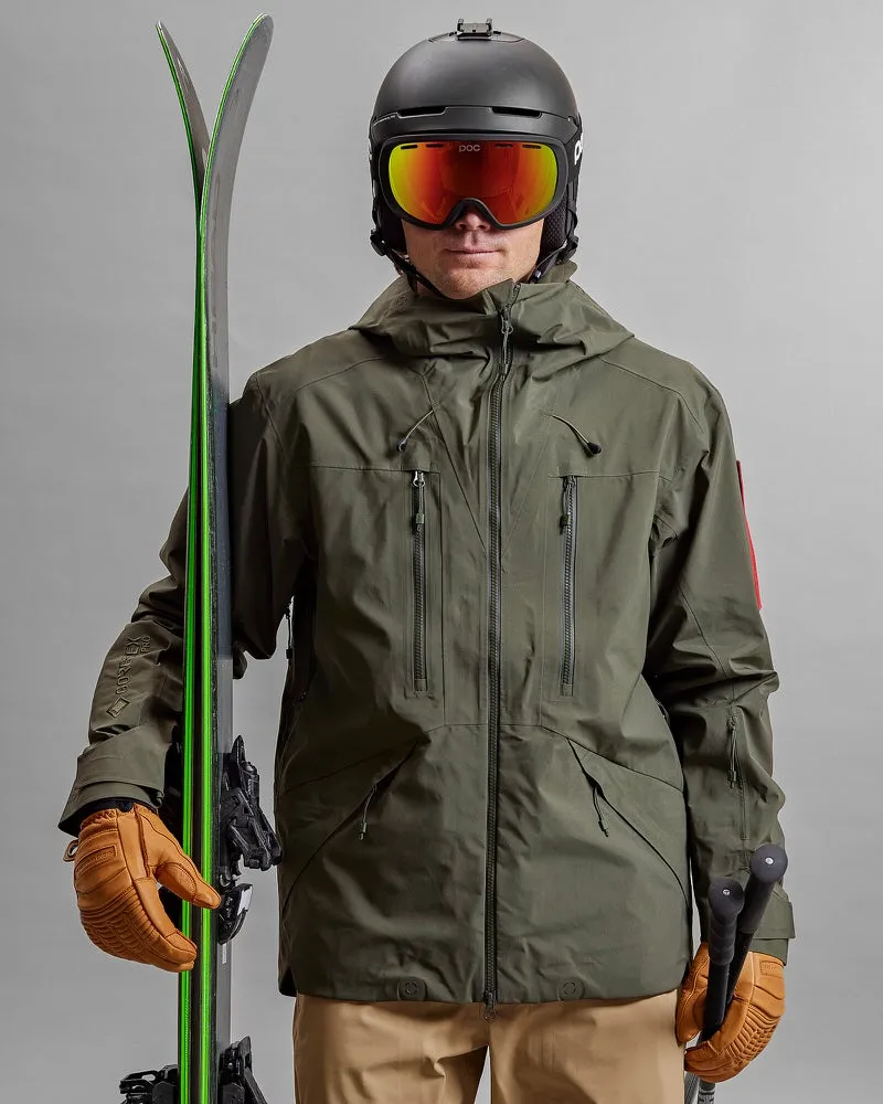 Person with skis, helmet and goggles wearing a green Z-2 HD GORE-TEX Pro 3L Shell Jacket.