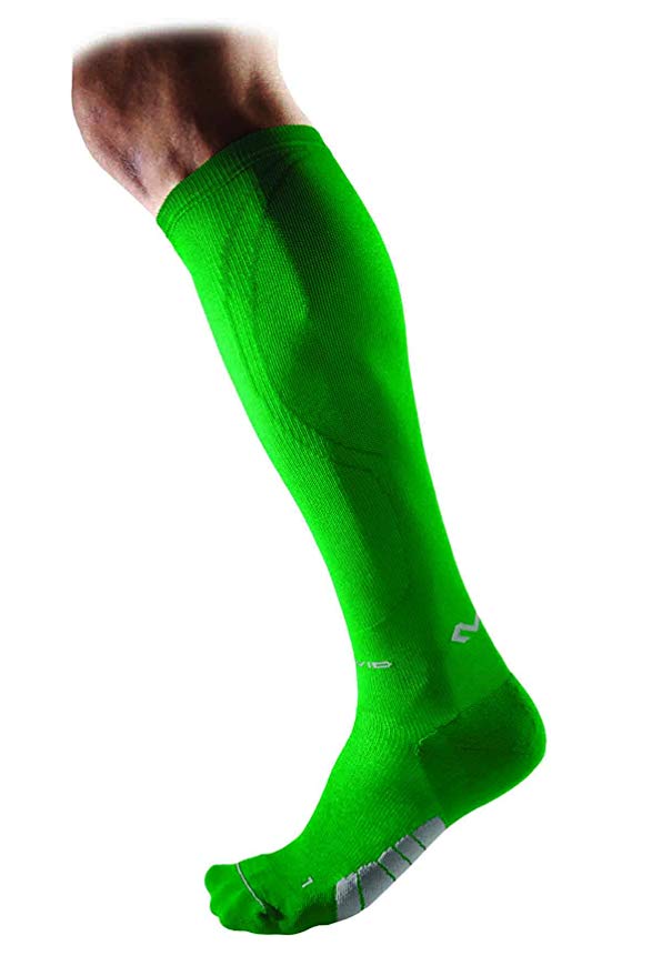 A leg wearing a long, green McDavid compression sock up to the knee.