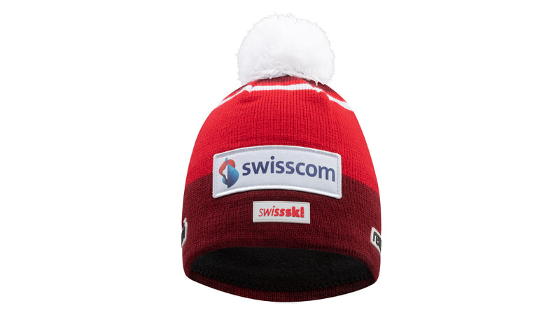 Rote Reusch Swiss-Ski Team Beanie mit weißem Bommel und "swisscom" Logo.