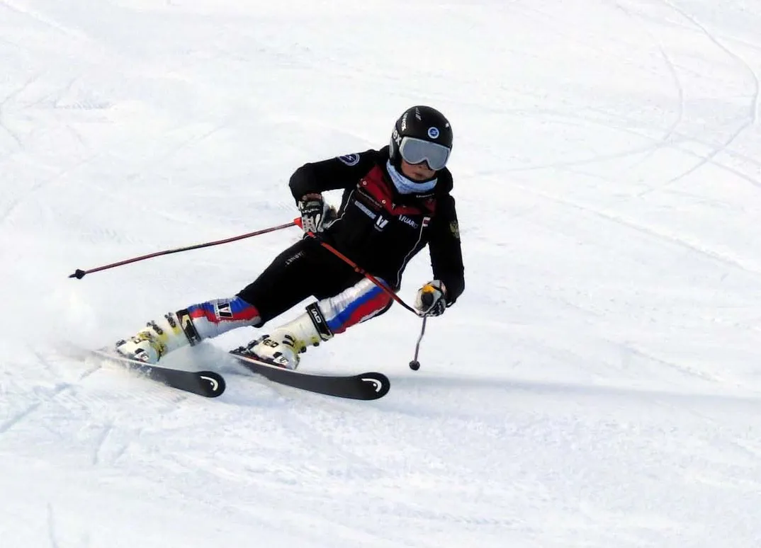 Skiers in action on snow, ski training, focus on body position and skiing technique.