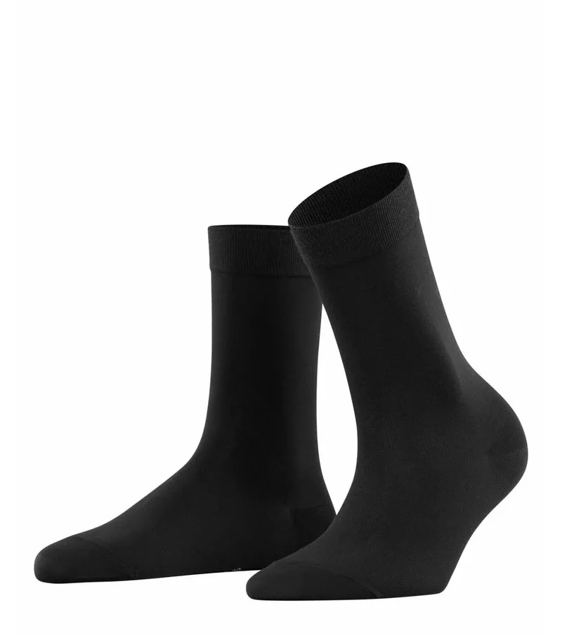 Two black, opaque women's socks, slightly curved, against a white background.