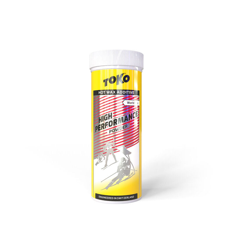 Toko Poudre rouge pour skis Boîte jaune contenant Toko High Performance Powder Red pour skis, avec motif de skieur.
