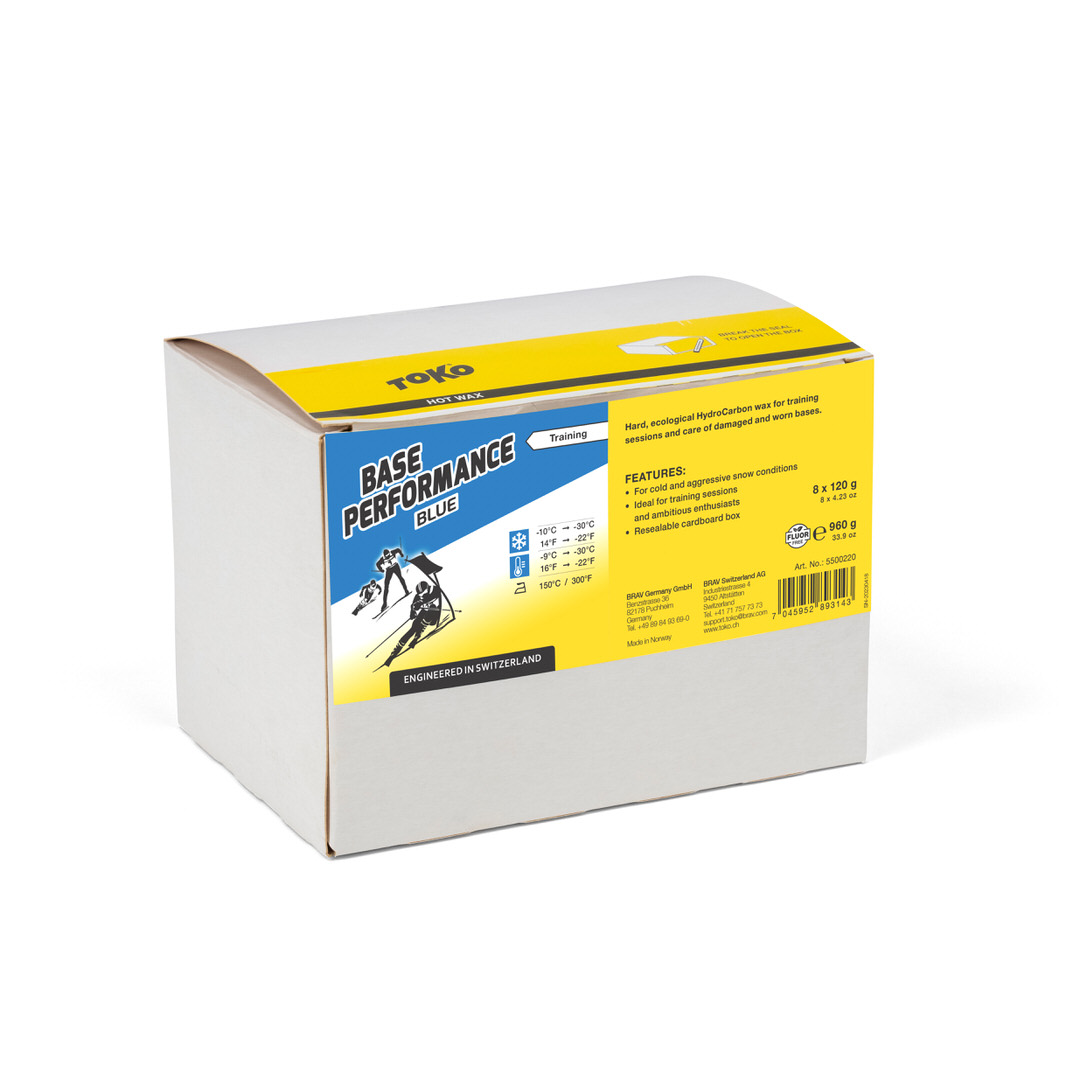 Verpackung Toko Base Performance Blue Heisswachs mit Logo, Texten und Skifahrer Illustration.