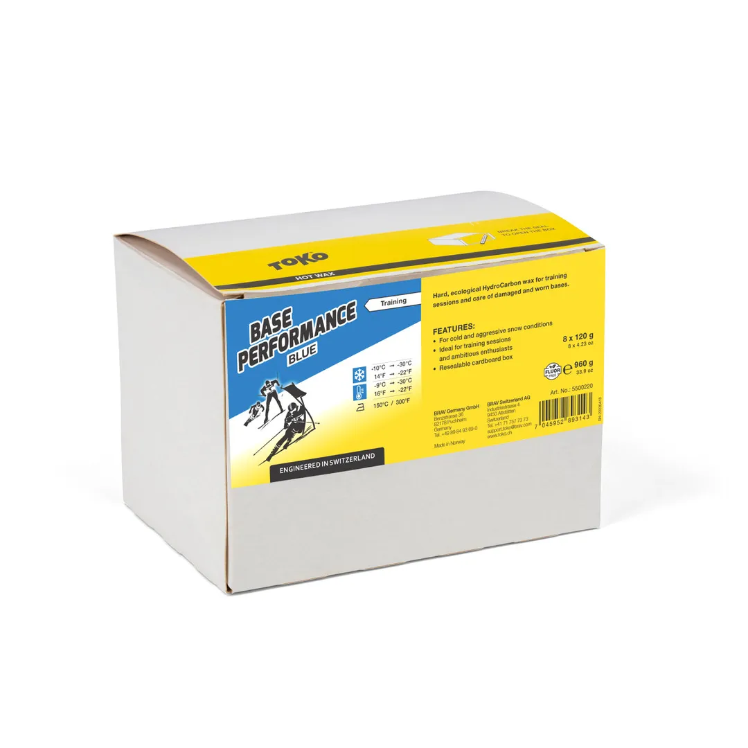 Verpackung Toko Base Performance Blue Heisswachs mit Logo, Texten und Skifahrer Illustration.