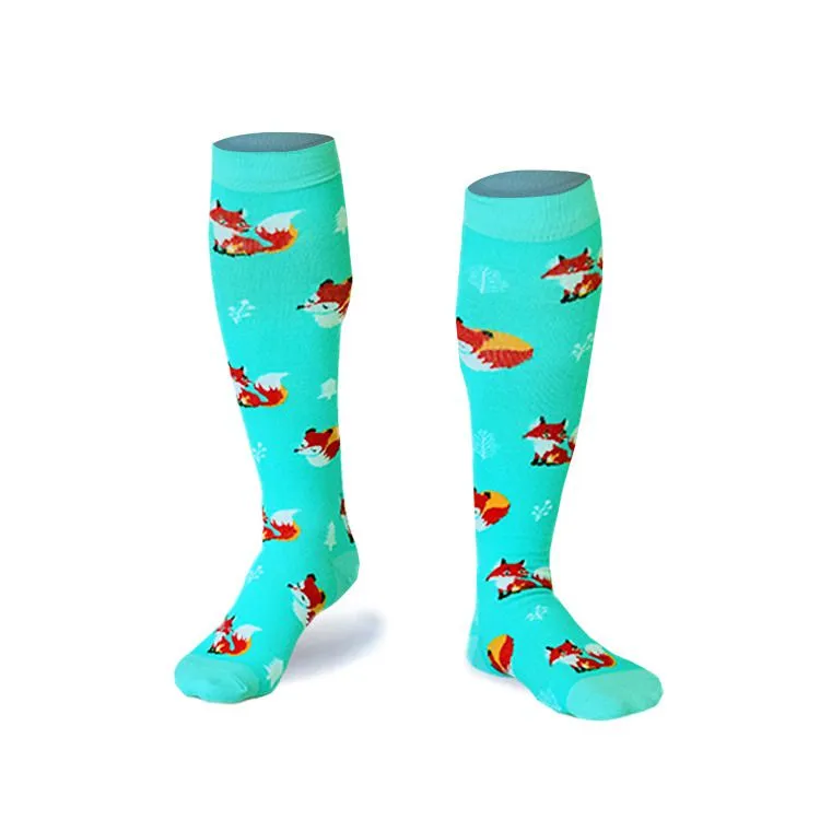 Light blue Fox ski socks with a fox pattern and small white snowflakes on a white background.