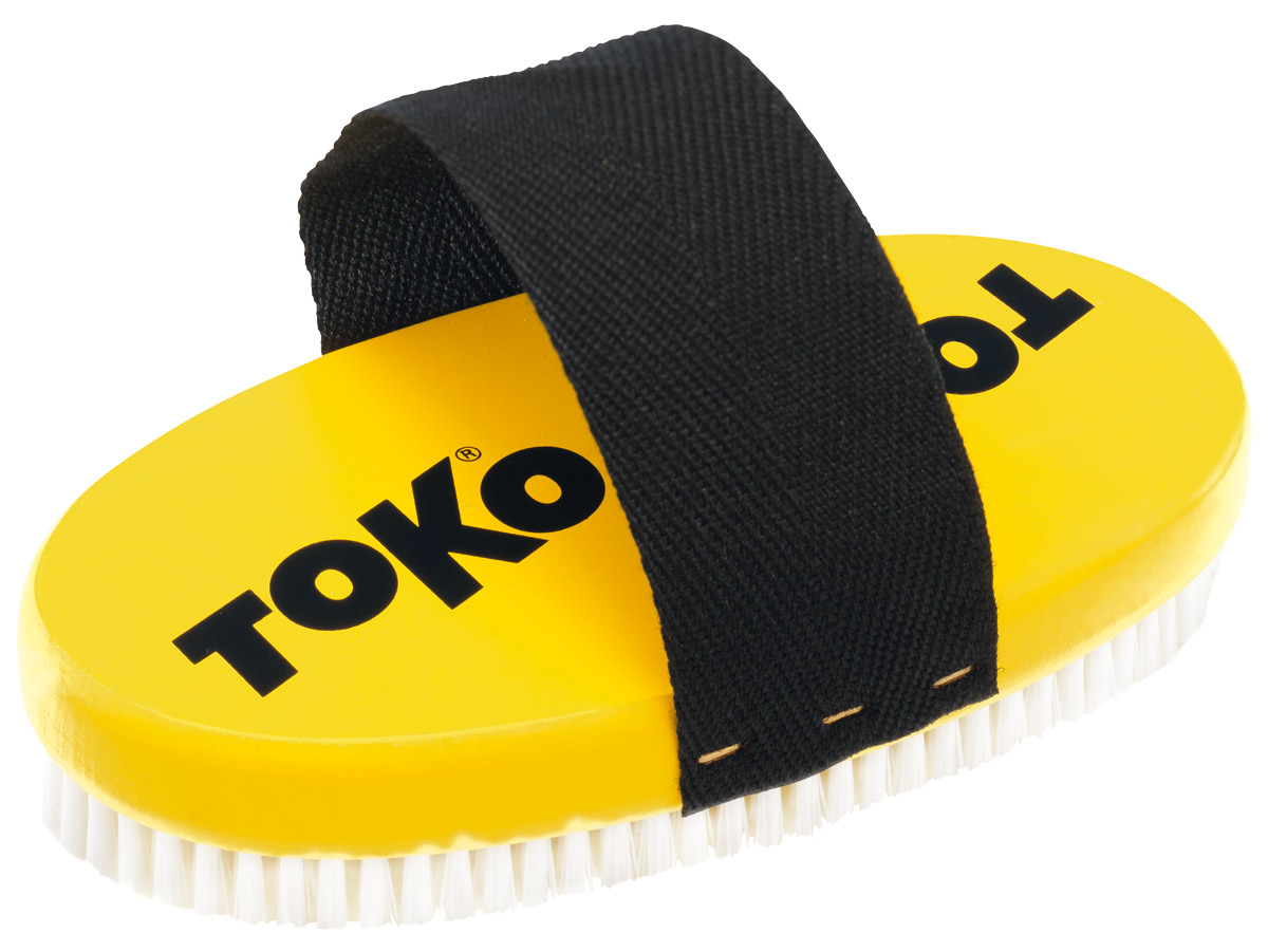 Gelbe Toko Bürste, ovale Form, Nylonborsten und schwarzer Halteriemen.