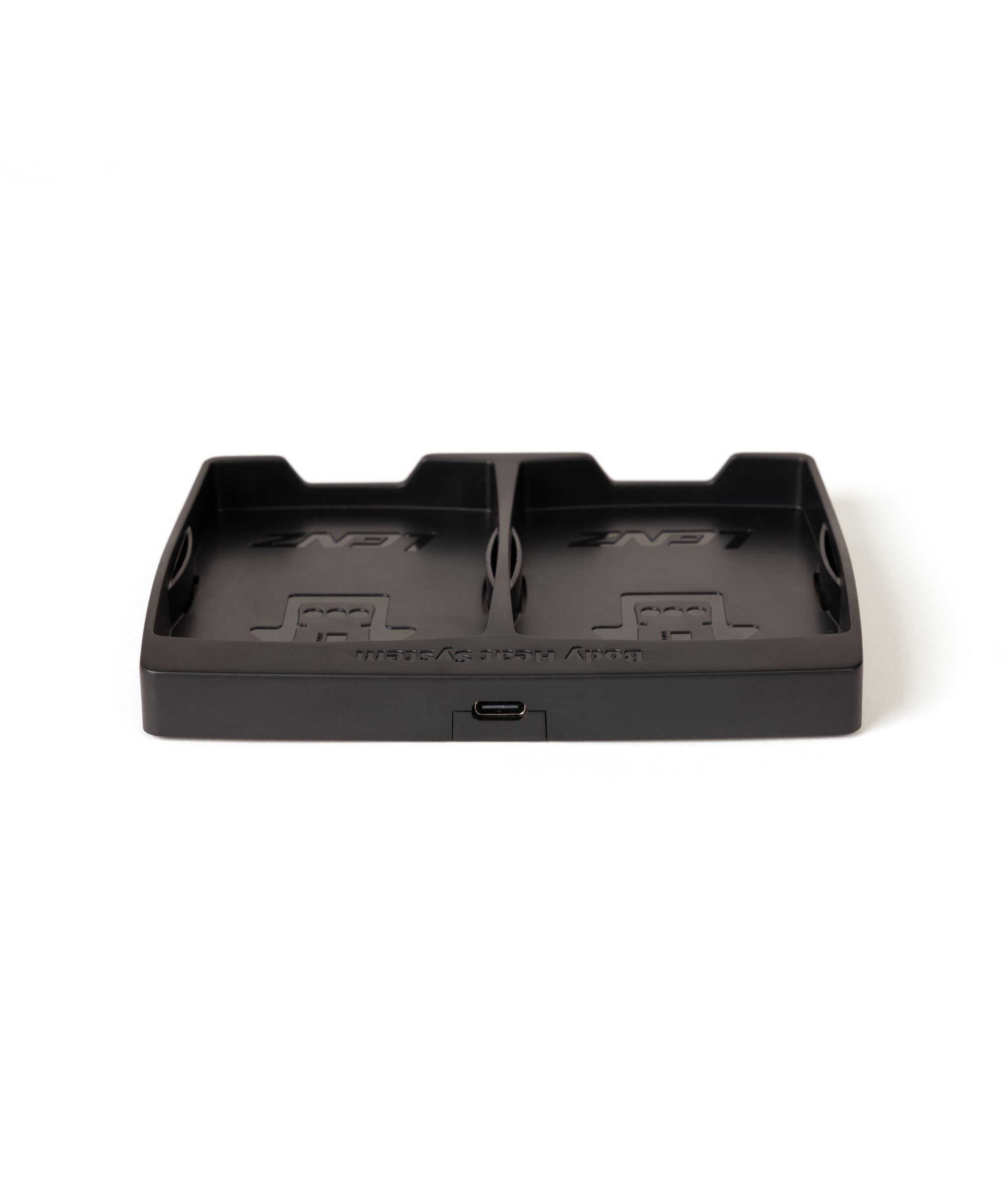 Schwarze Ladestation mit USB-C Schwarze Ladestation mit zwei Fächern und USB-C Anschluss auf einer weißen Oberfläche.