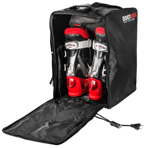 Opened, black Bootdoc ski boot heater bag with red ski boots and power cable.