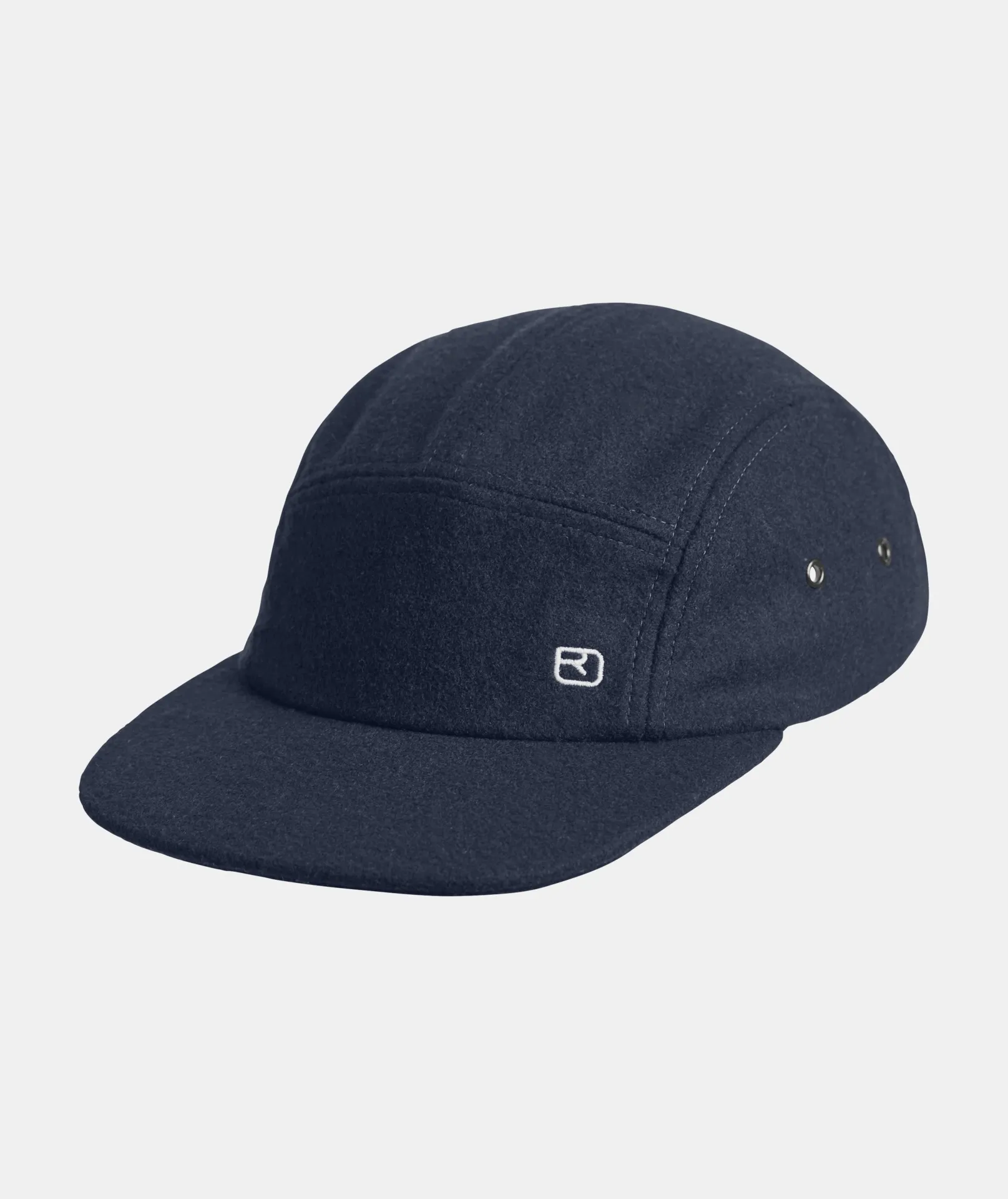 Navy blue wool cap with short peak and white logo on the side. Metal eyelets provide ventilation.