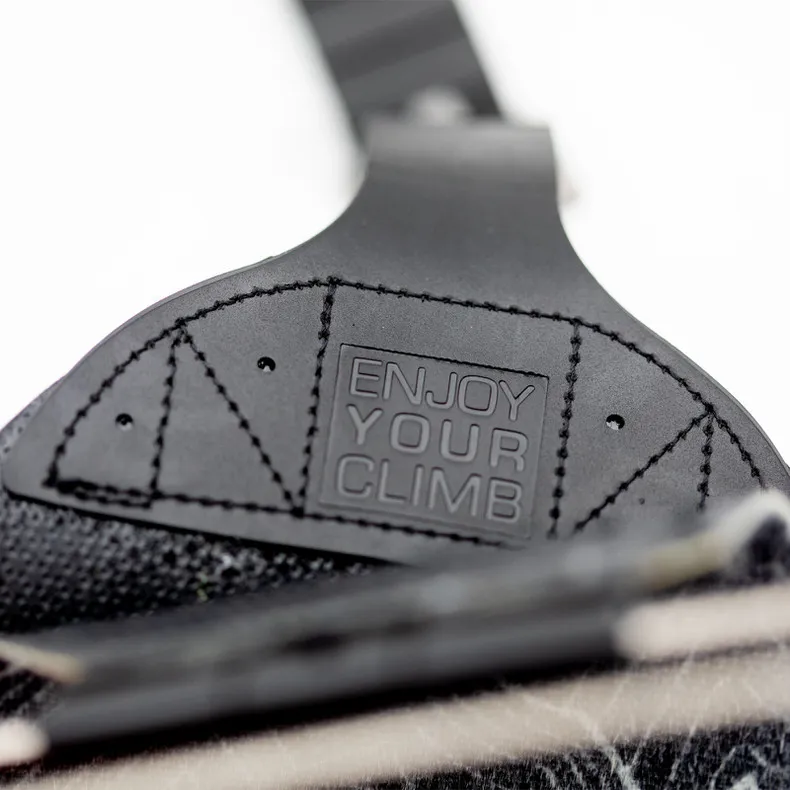 Detailed view of the Jones Nomad PRO splitboard skins with the inscription "Enjoy Your Climb" on the tail clip.