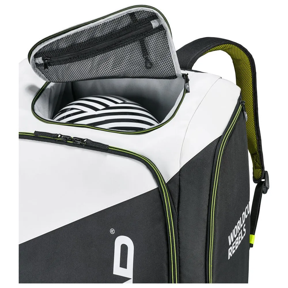 Offener Head Rebels Racing Backpack L, zeigt Helm in Helmtasche. Schwarz-weißes Design mit neongelben Akzenten.