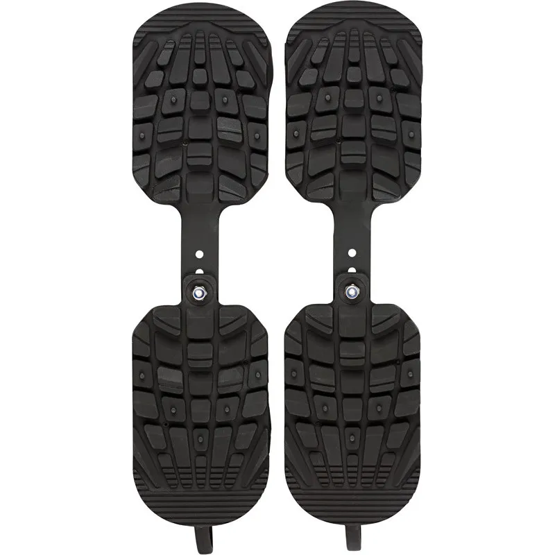 Two black Sidas Skiboot Traction soles with tread, connected by an adjustable strap.