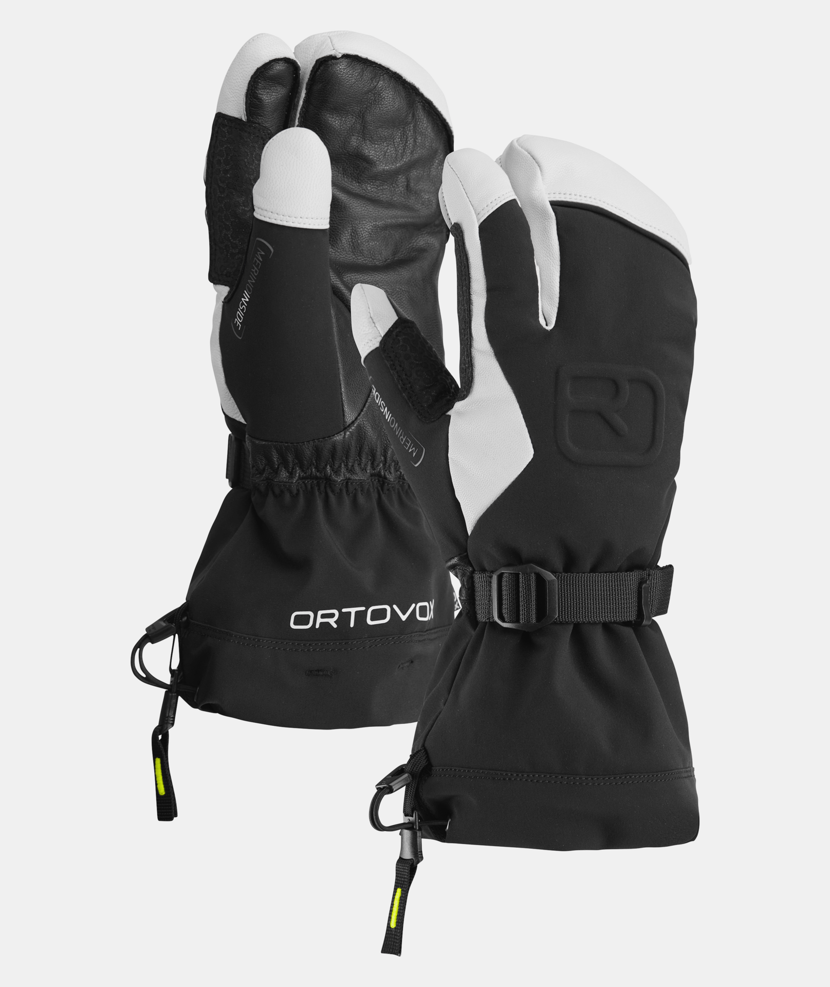 Deux gants Merino Freeride 3 doigts en noir et blanc, manchettes avec logo Ortovox et lanières de poignet visibles.