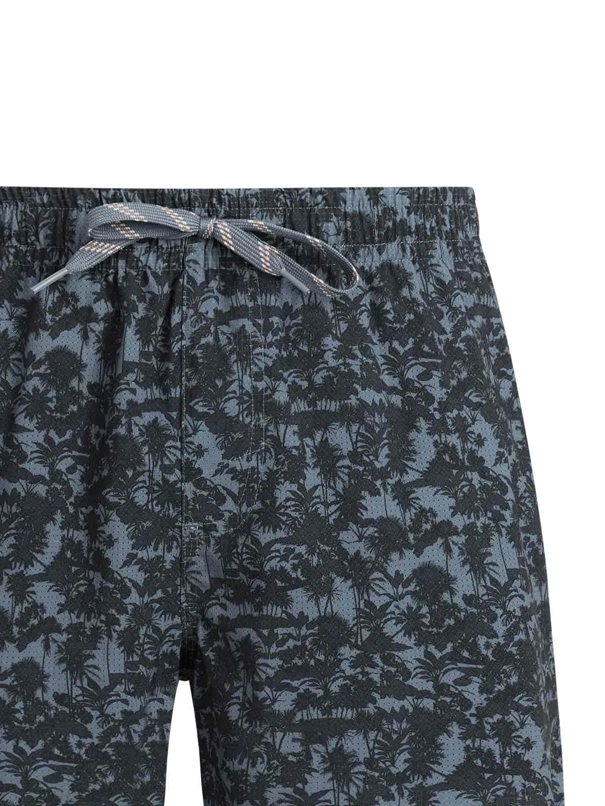 Close-up of a pair of shorts with a dark palm tree pattern and a gray-brown cord on the elastic waistband.