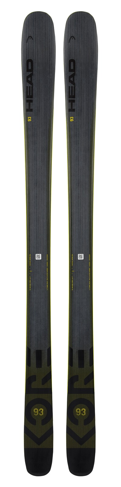 Two skis, Head Kore 93, anthracite and yellow, standing, with gray texture and yellow edges.