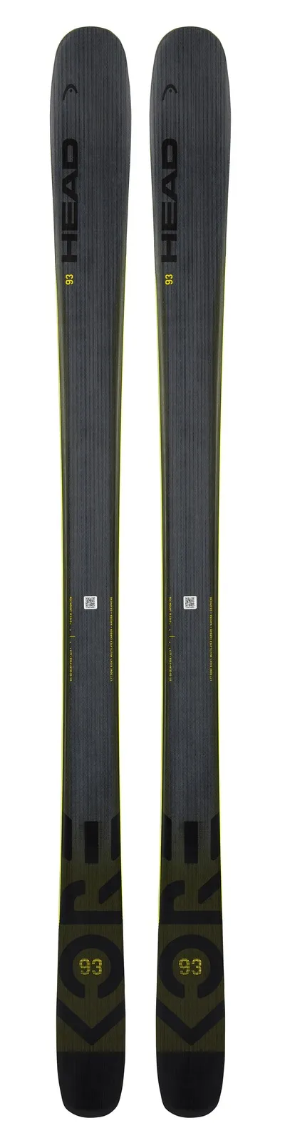 Two skis, Head Kore 93, anthracite and yellow, standing, with gray texture and yellow edges.