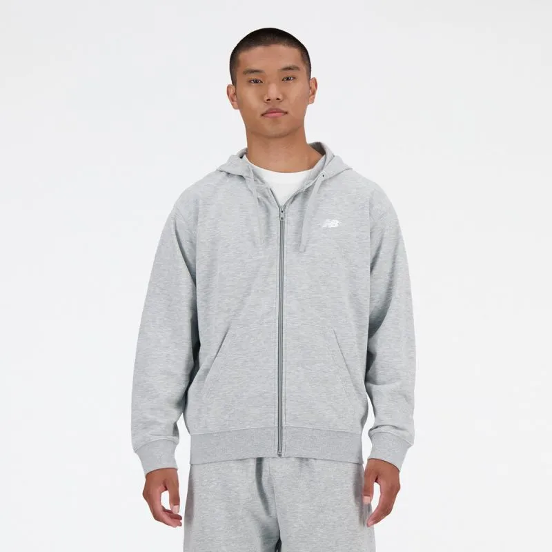 Man wearing a grey New Balance French Terry FZ hoodie with full-length zipper and hood. There is an NB logo on the front.
