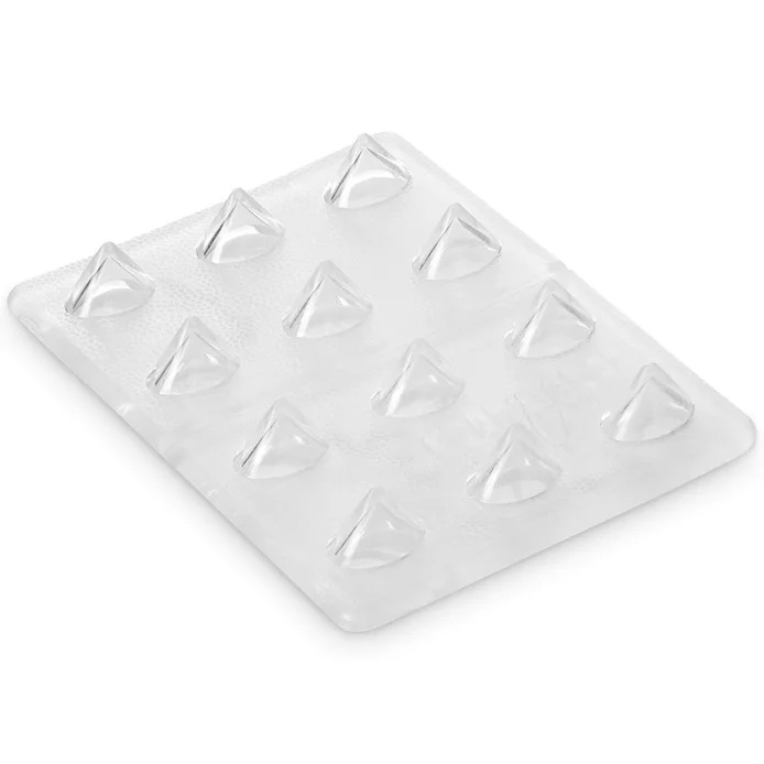 Clear, rectangular pad with 12 transparent, pyramid-shaped spikes arranged in four rows. The slightly textured surface of the Crab Grab Mini Shark Teeth Stomp Pad provides extra grip and is made of flexible rubber.