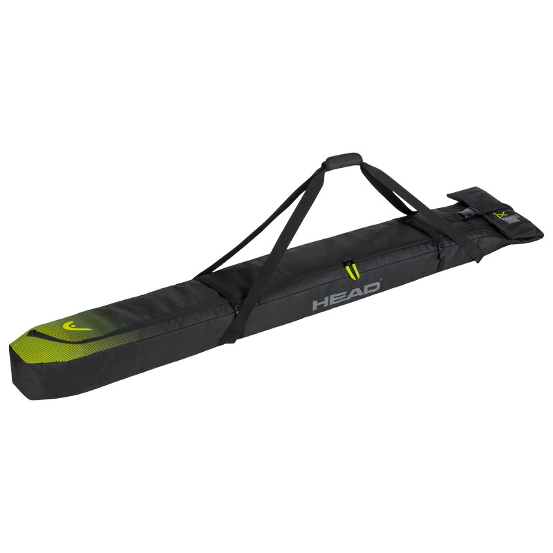 Black Head single ski bag with carrying straps and green logo at the end.