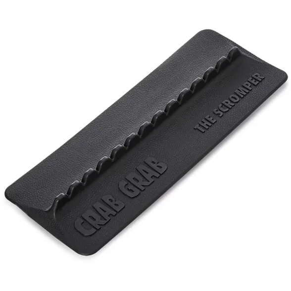 Black, rectangular Crab Grab Scromper Stomp Pad with a textured surface. Seven raised, wave-shaped ridges along one long side for cleaning shoe soles. Embossed with: “Crab Grab,” “THE SCROMPER.”