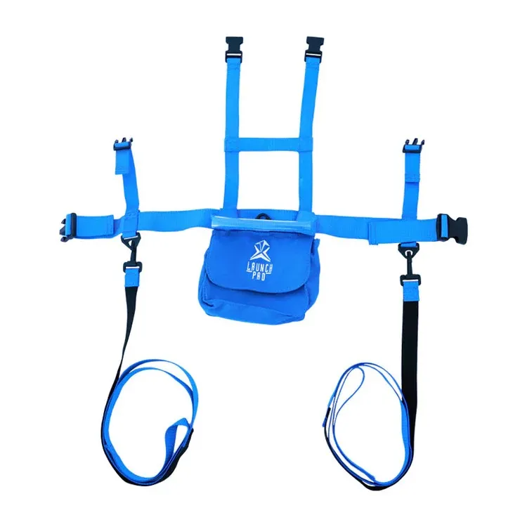 Bright blue children's ski harness with adjustable shoulder and waist straps featuring black buckles. A small blue pocket with a white "LAUNCH PRO" logo is centered on the front. Two blue leashes with black handles hang from the waist strap.