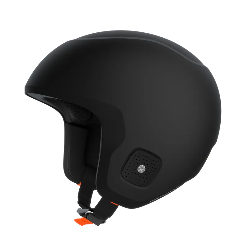 Black ski helmet with chin strap and orange accents, insulated against a white background.