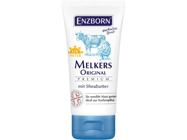 Tubo bianco di Enzborn Melkers Original Premium Shea Butter con illustrazione di mucca e mungitore. Filtro UV e testo.