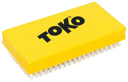 Yellow Toko Polishing Brush with white bristles, for ski base care.