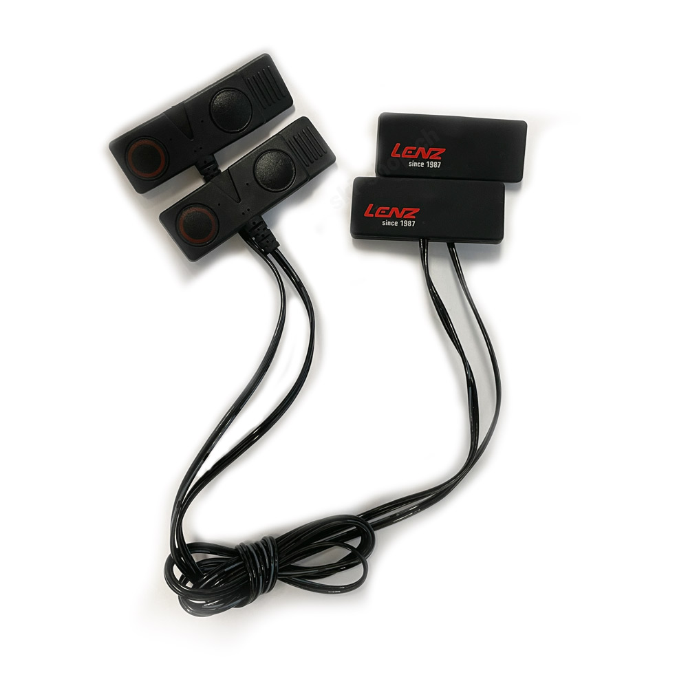 Black extension cable Black Lenz extension cable, with plugs and sockets for battery packs, on a white background.