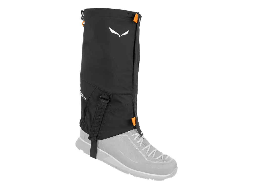 Black Salewa GTX gaiter on the foot, with visible sole strap and brand logo.