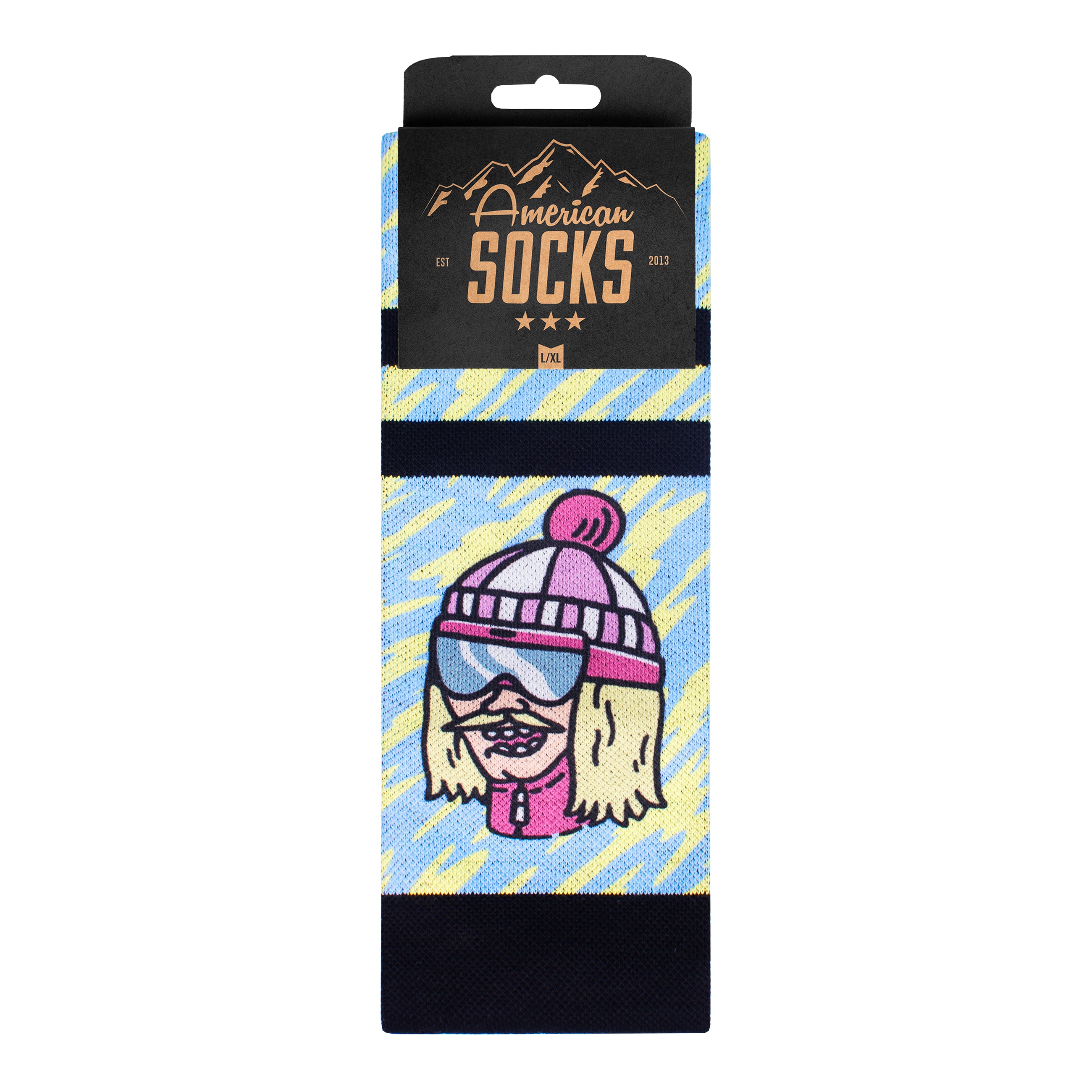 Comic Ski Socken Verpackte Snow Socks mit Comicfigur im Ski-Look auf blau-gelben Hintergrund.