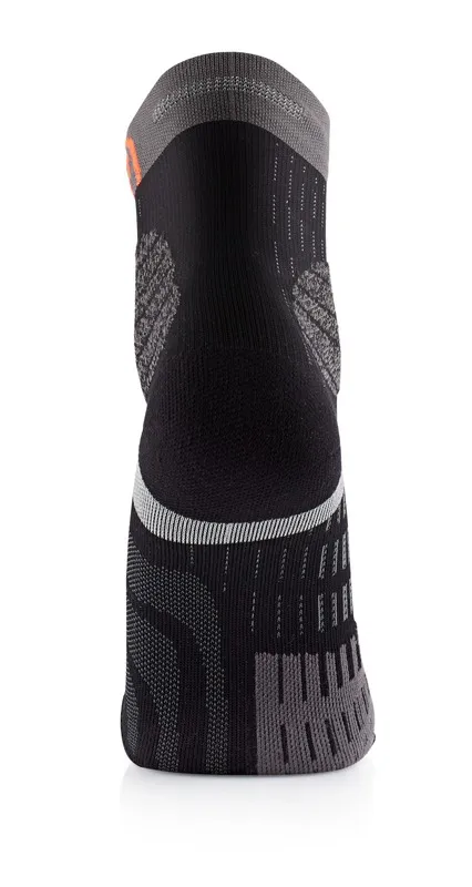 A gray and black sock, seen from behind, with different knitting patterns.