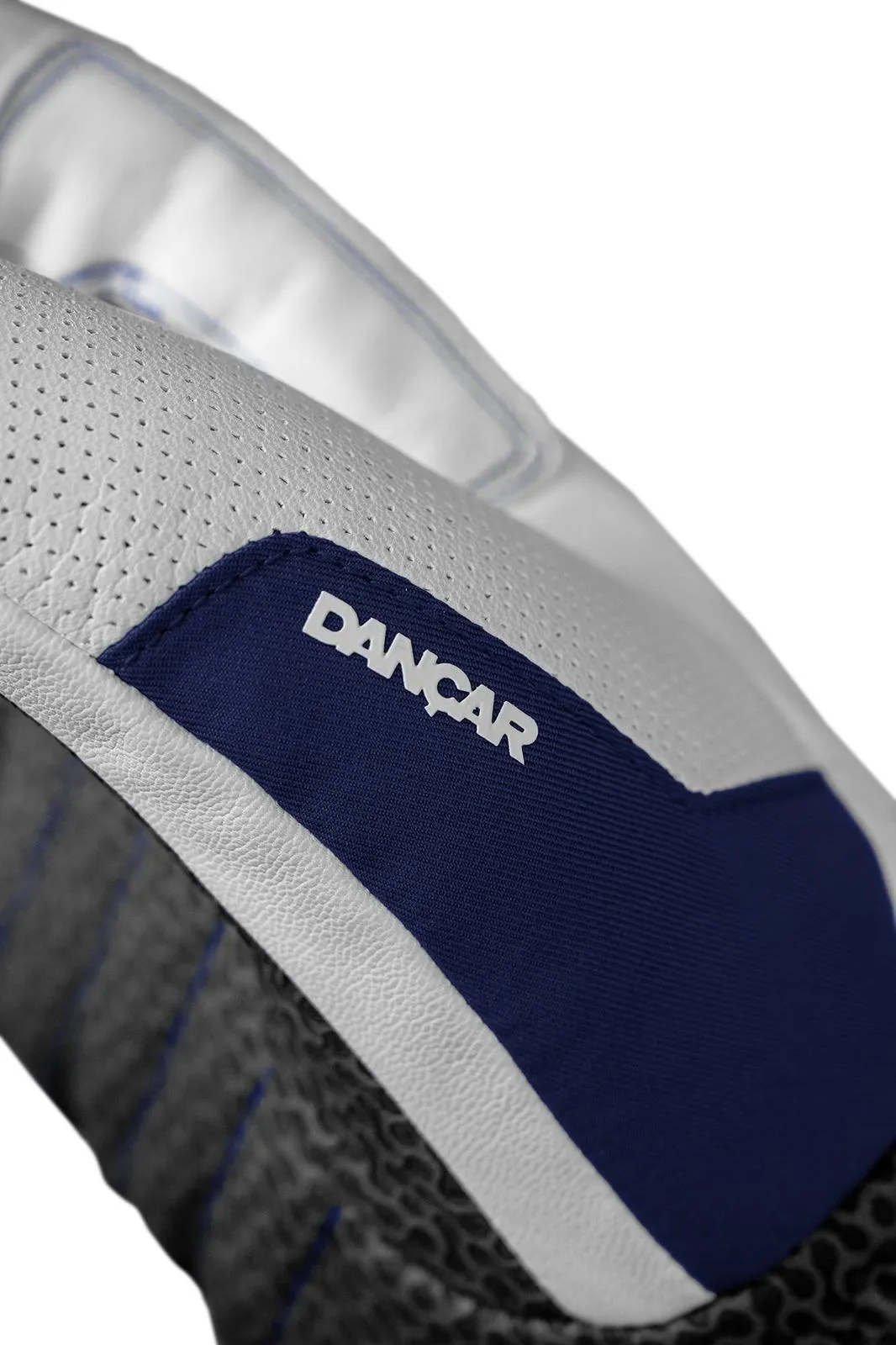 Detailed view of a white leather glove with blue fabric insert and the lettering "DANCAR".