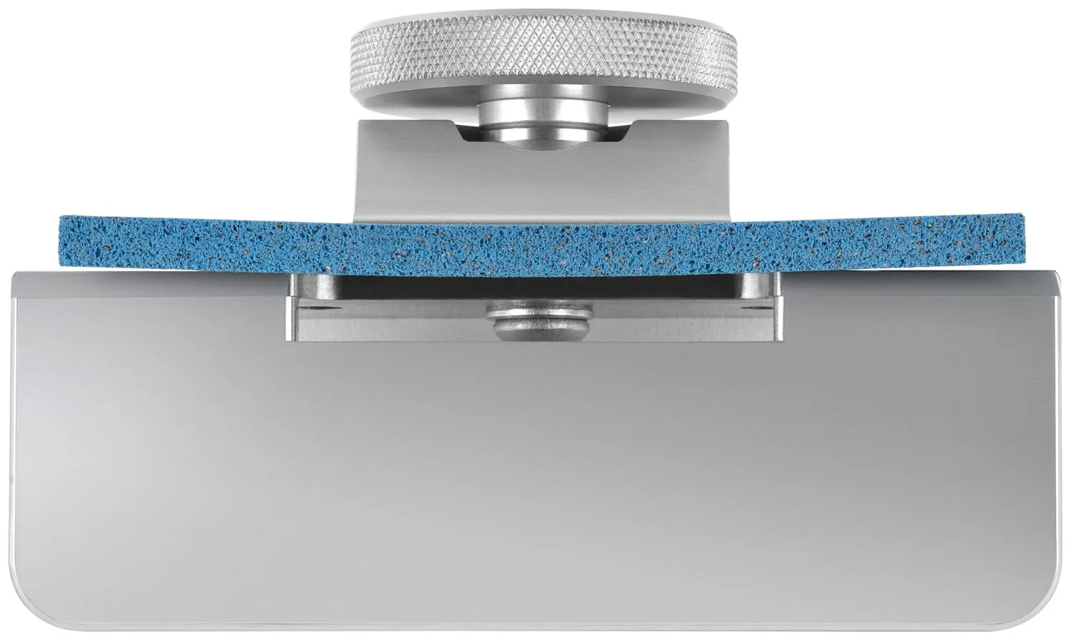 Close-up of a silver metal device with a blue fabric sample clamped between the two metal plates.