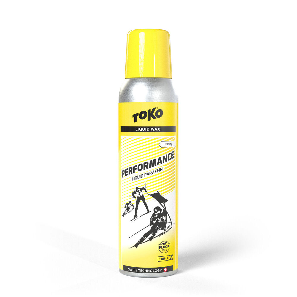 Gelbe Sprühflasche Toko Performance Liquid Yellow Flüssigwachs mit Abbildung von Skiläufern.