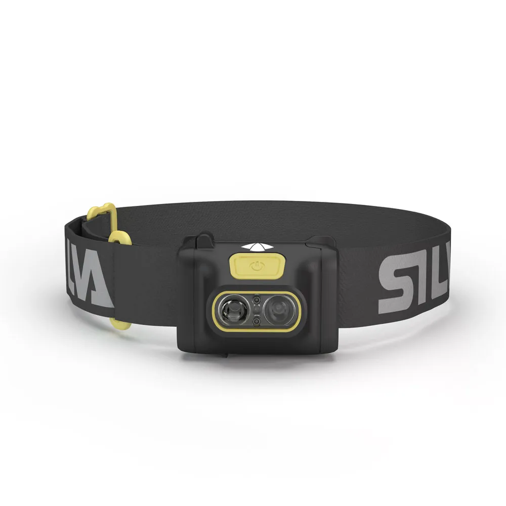 Black Scout 3 headlamp with yellow accents and adjustable, labeled headband against a light background.