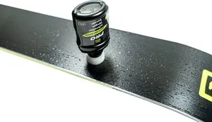 Ski with Gigaglide Pro 50ml bottle for application. Coating visible on ski surface.