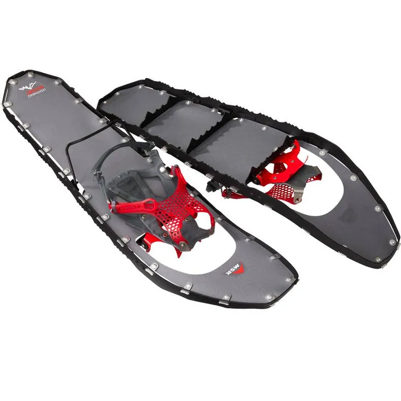 Two MSR Lightning Ascent M22 snowshoes in black, with red binding and circumferential crampon prongs, on a white background.
