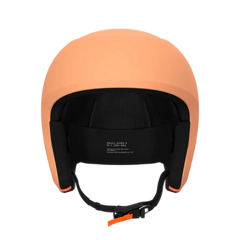 A peach-colored ski helmet, seen from the front, with black interior and chin strap.