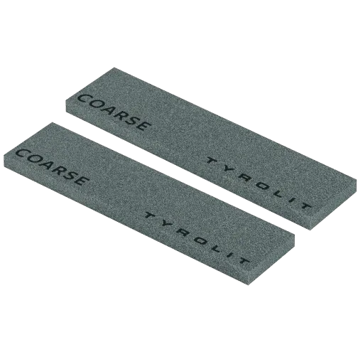 Two gray, elongated whetstones with the inscription "COARSE TYROLIT" lie parallel to each other.