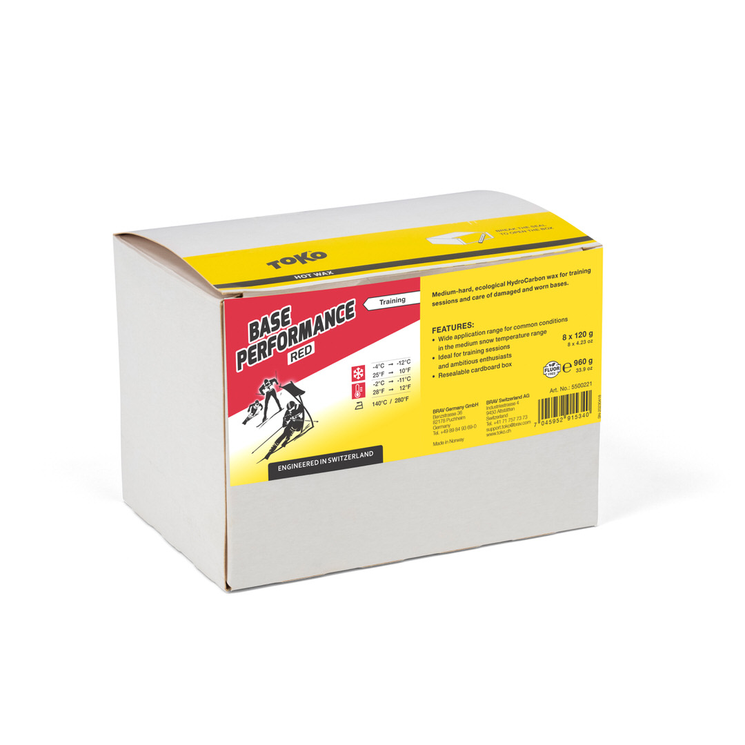 Verpackung Toko Base Performance Red Heisswachs mit Logo, Produktinformationen und Skifahrer-Illustration.