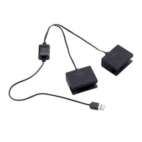 Schwarzes, elektronisches Gerät mit zwei Pads, Kabeln, einem USB-Stecker und einem kleinen Adapter.