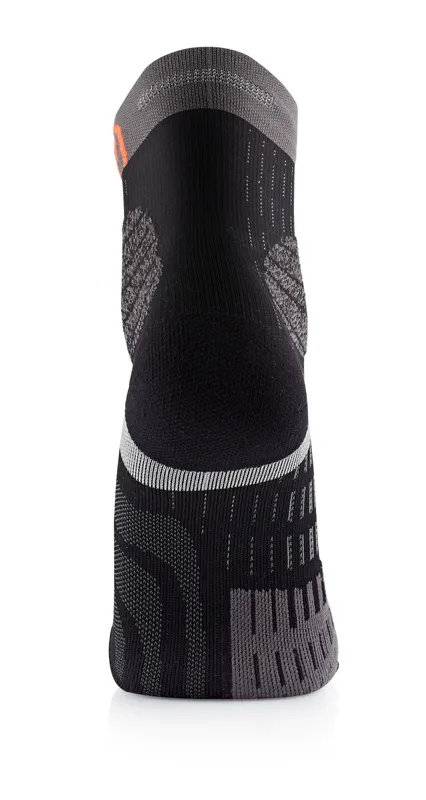A gray and black sock, seen from behind, with different knitting patterns.
