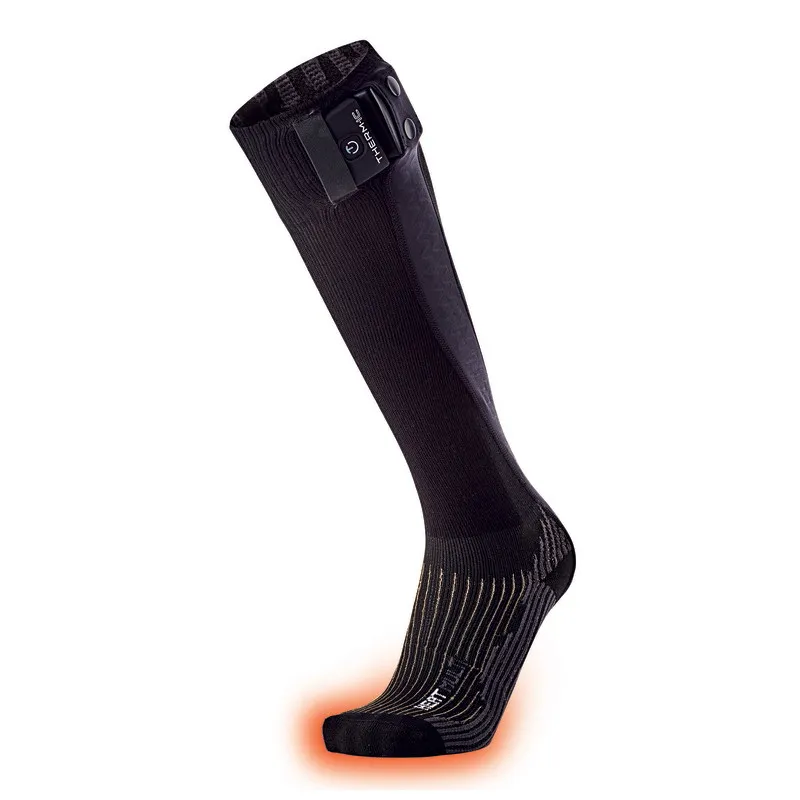 A black Therm-ic Powersock Heat Multi, with rechargeable battery on the cuff, foot area lights up red.