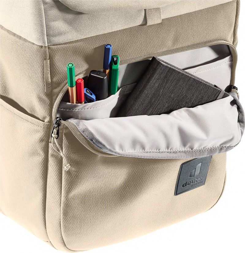 Detailed view of the Sand-Bone UP Sydney backpack with open compartment. Pens, notebook and zipper visible.